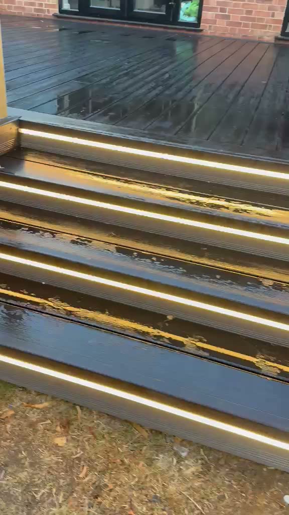 Walkthrough of warm white LED lighting integrated along outdoor decking and step edges