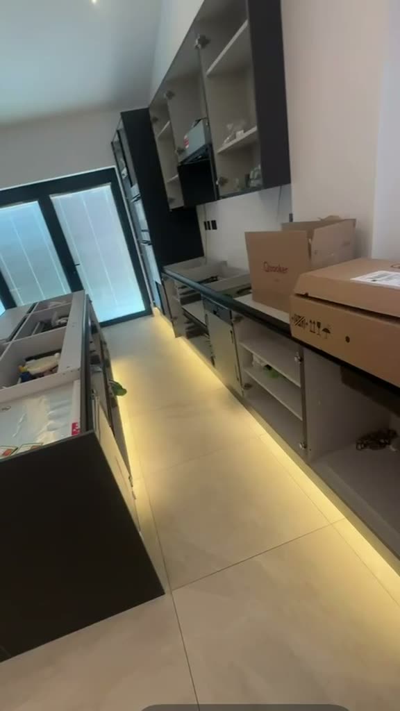 Walkthrough of an open-plan interior with perimeter cove lighting, linear ceiling lights and illuminated joinery